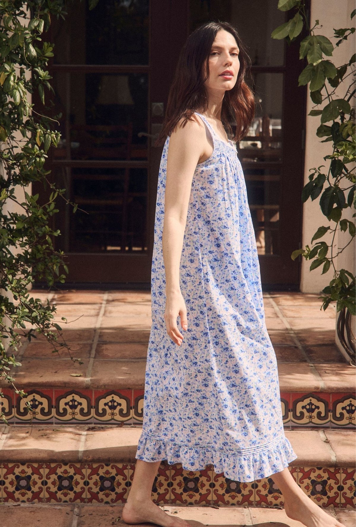 A lady wearing The "Eileen" Spring Meadow Cotton Lawn Ballet Nightgown walking by