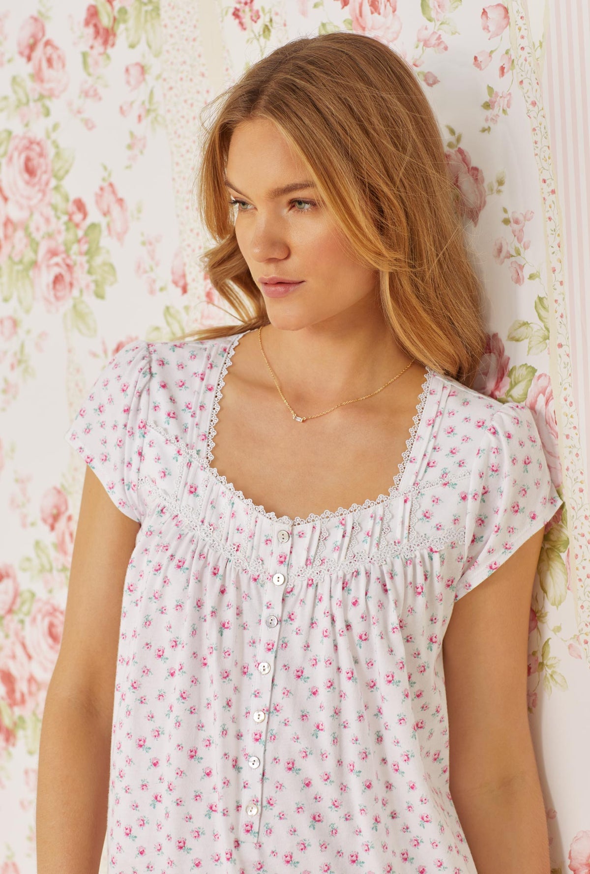 A lady wearing pink cap sleeve short cotton knit nightgown with joyful rose print.