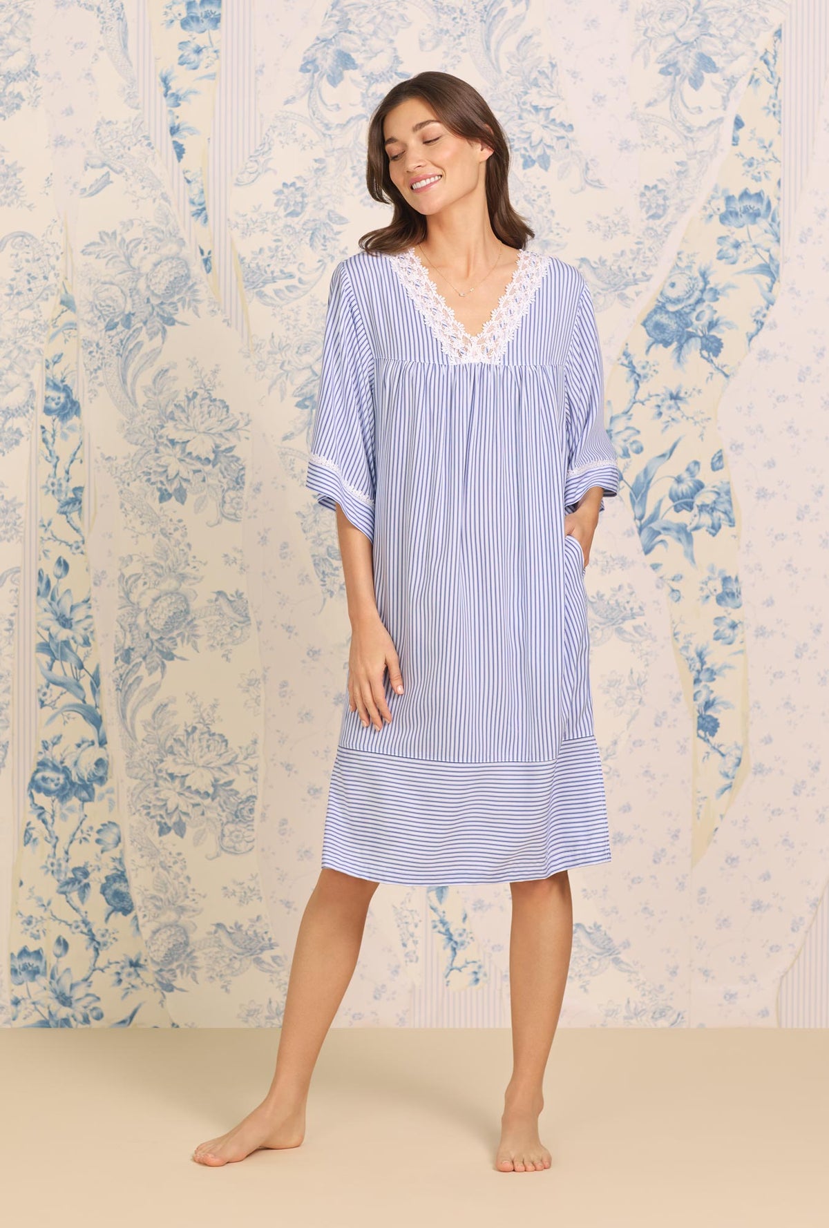 A lady wearing blue short Sleeve Navy Stripe Classic Caftan with Ecovero print