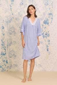 A lady wearing blue short Sleeve Navy Stripe Classic Caftan with Ecovero print