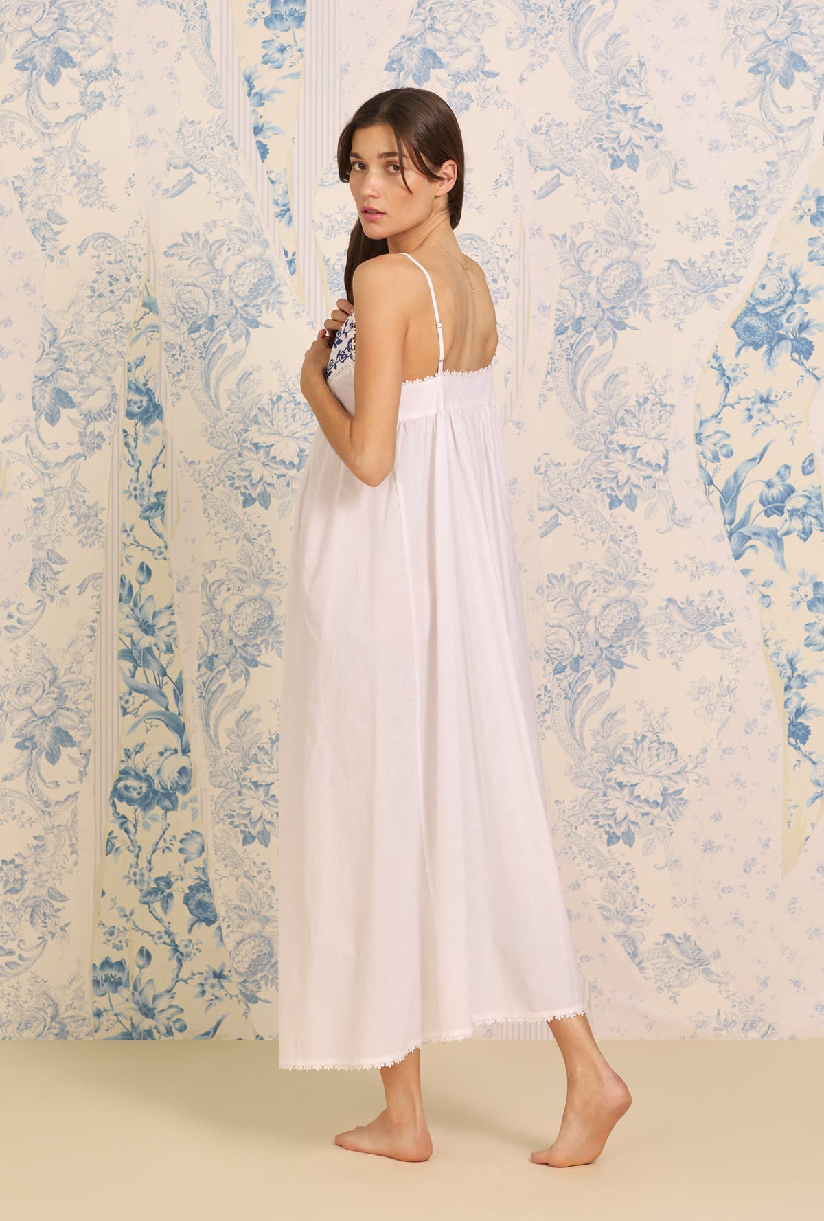 A lady wearing white sleeveless Samantha&quot; Cotton Nightgown with Dune Beach Embroidered print