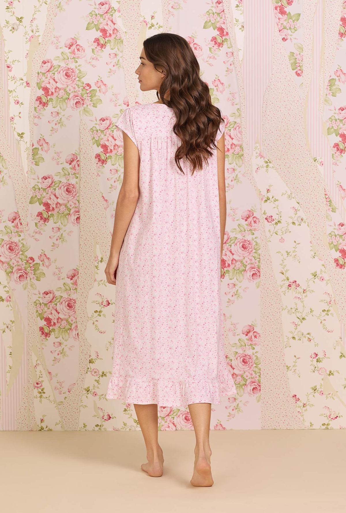  A lady wearing pink Cotton Knit Long Cap Sleeve Nightgown with spring garden print