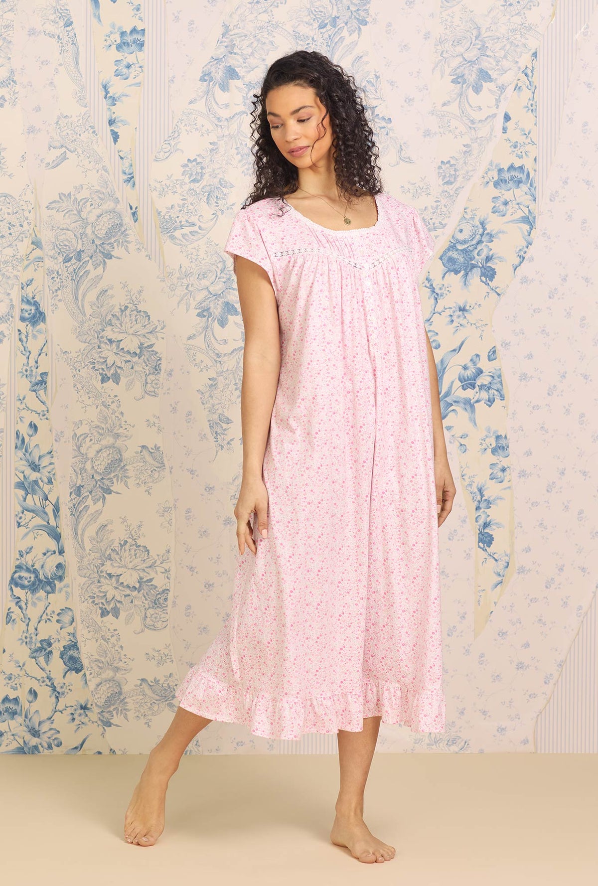  A lady wearing plus size pink Cotton Knit Long Cap Sleeve Nightgown with spring garden print