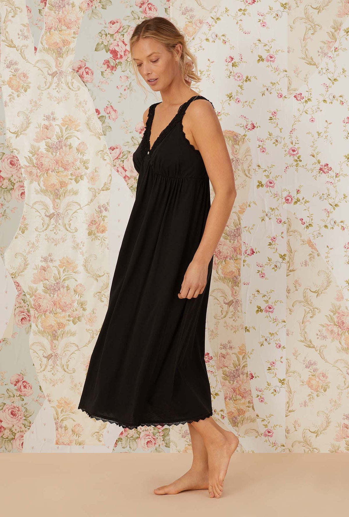 A lady wearing black sleeveless villa blanca knit nightdress.