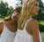 Two ladies wearing white gowns