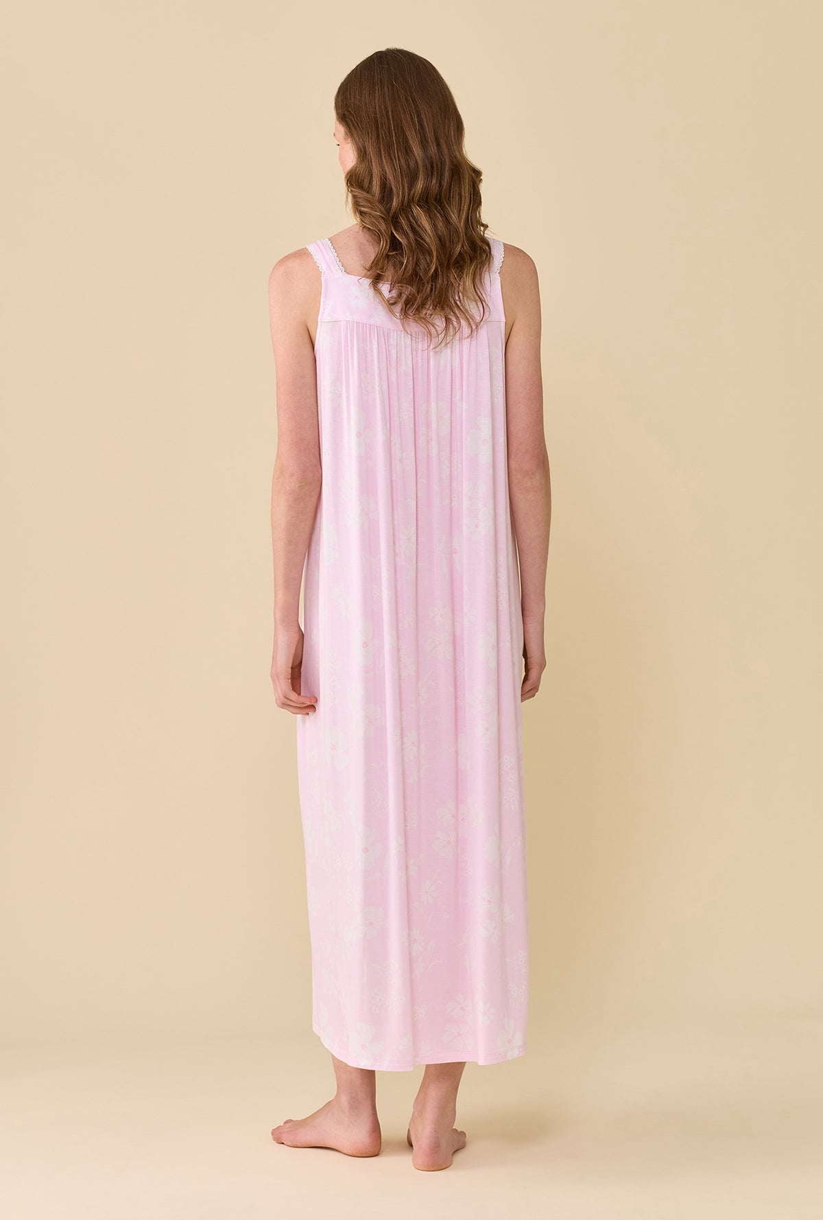 A Lady Wearing The "Eileen" Pink Posy Tencel™ Modal Ballet Nightgown facing back in a standing pose
