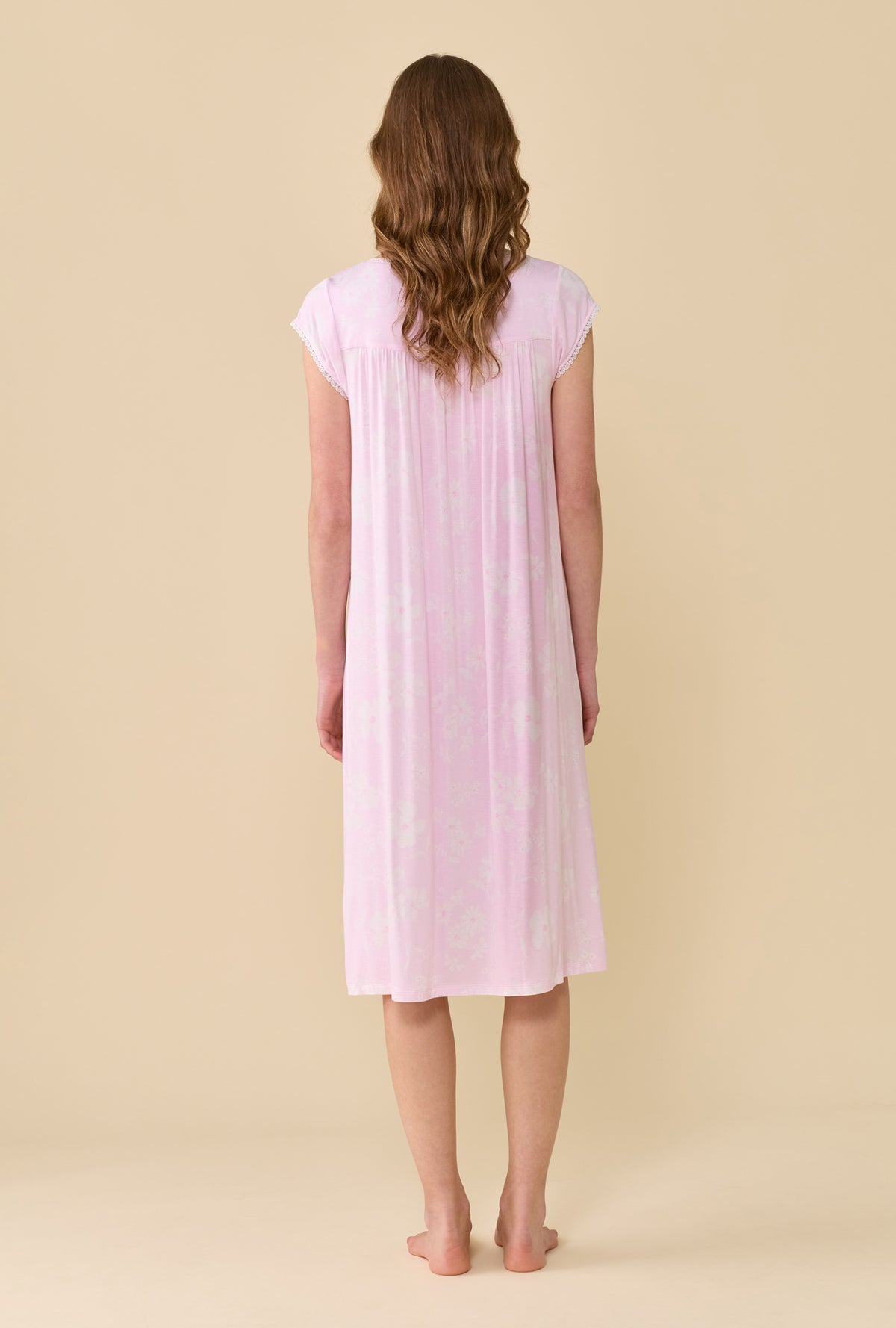A Lady Wearing Pink Posy Tencel™ Modal Waltz Nightgown facing back with a straight standing pose