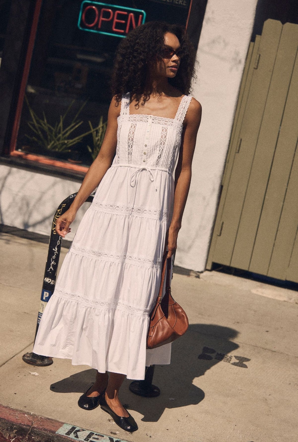 A lady wearing The "Elise" Soft White Cotton Maxi Dress looking right side