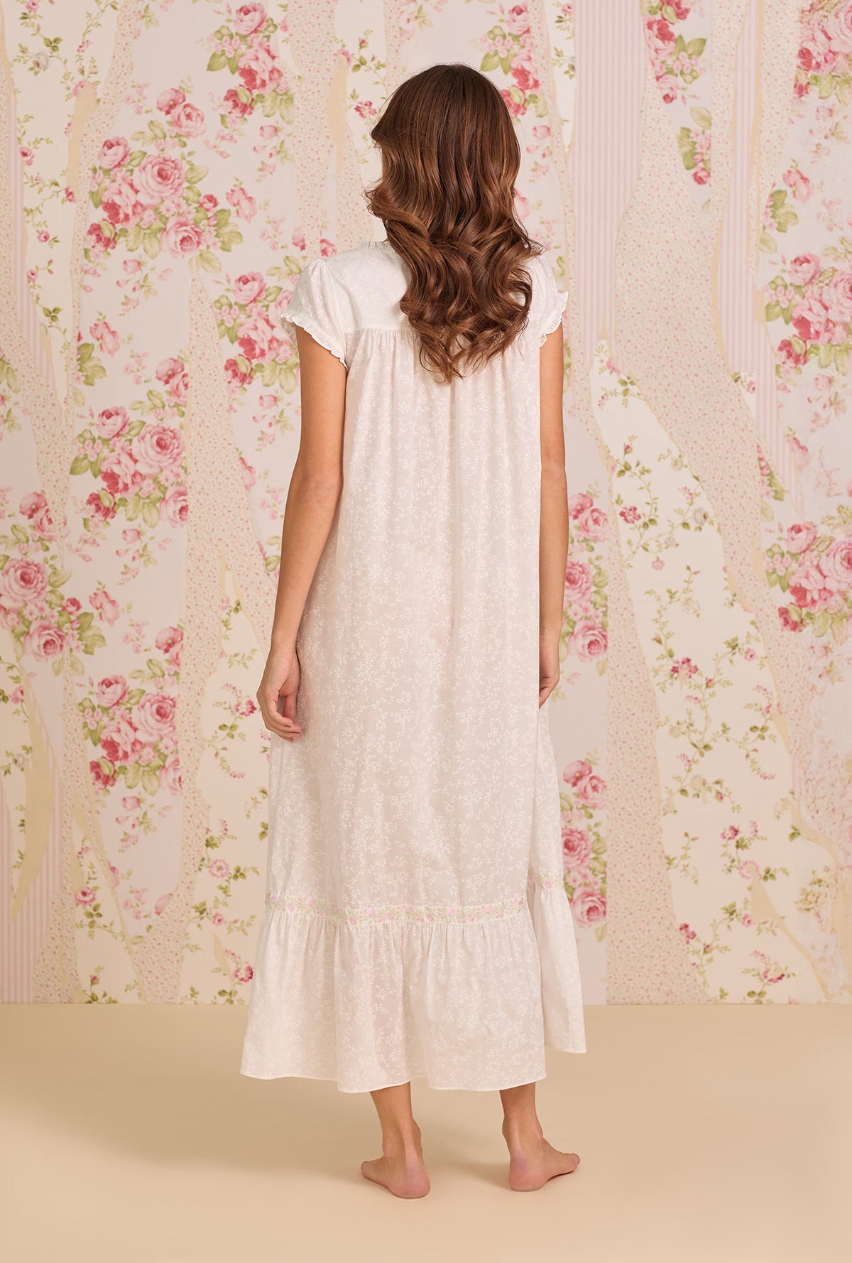A Lady Wearing Shadow Floral Cotton Lawn Button Front Robe posing back view of the dress