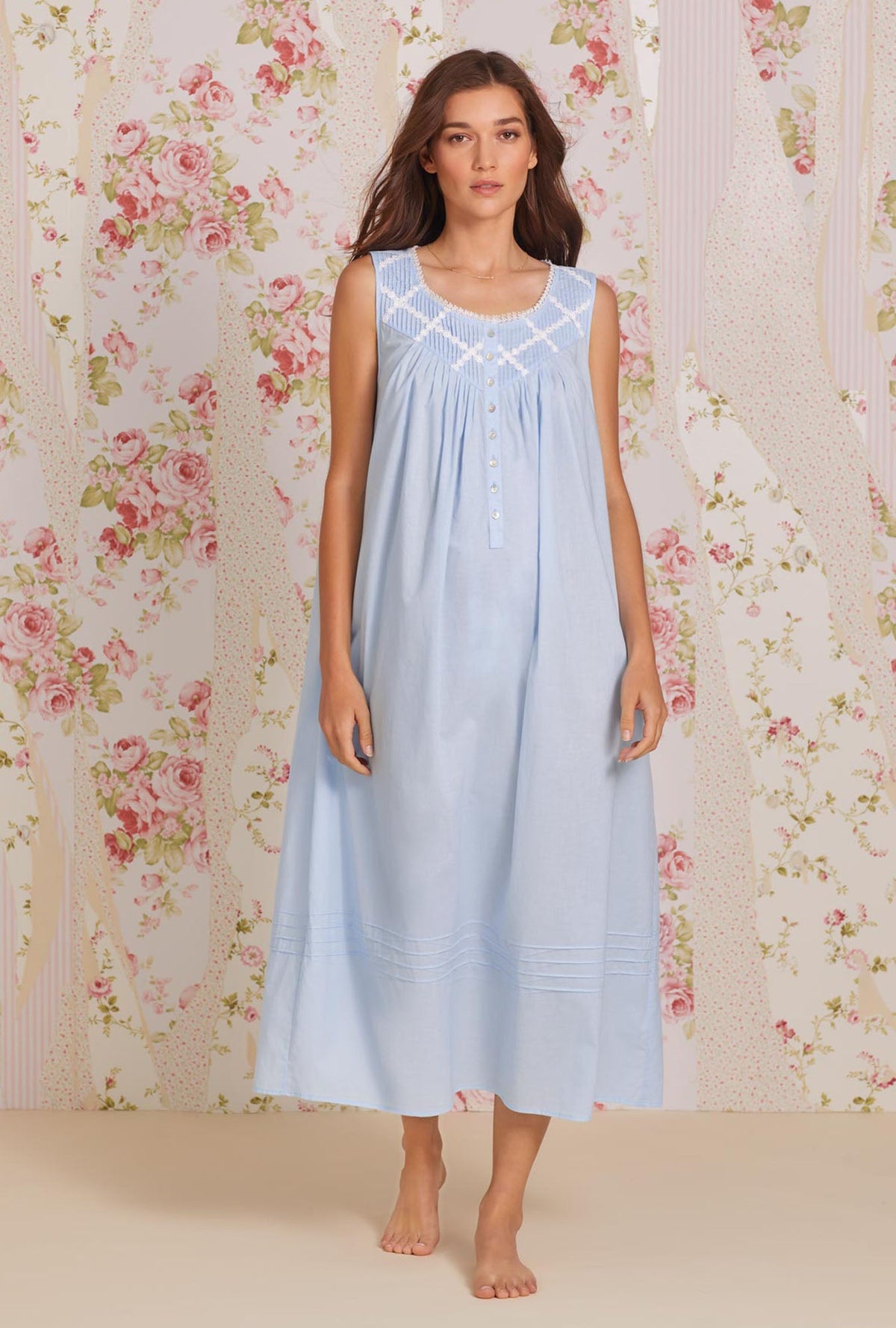 A lady wearing blue sleeveless poetic ballet gown front pose