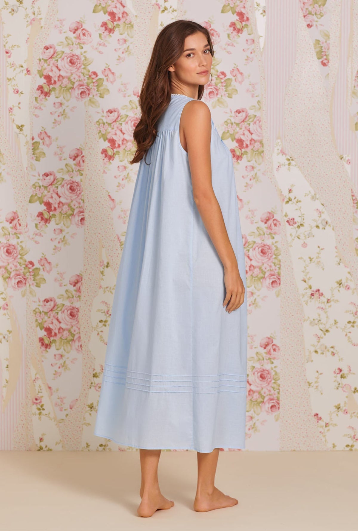 A lady wearing blue sleeveless poetic ballet gown right pose