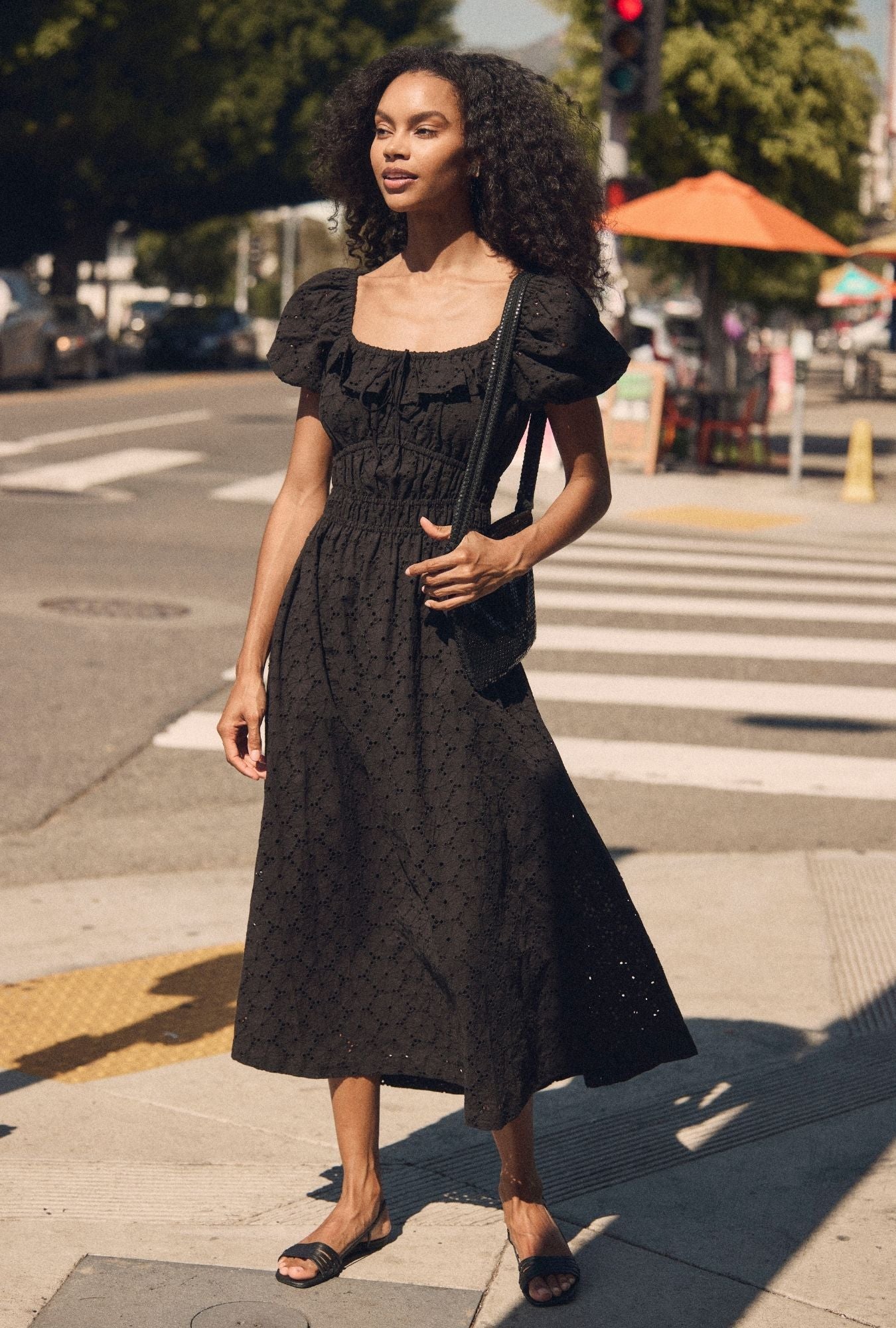 A lady wearing The "Catalina" Iconic Black Cotton Maxi Dress 