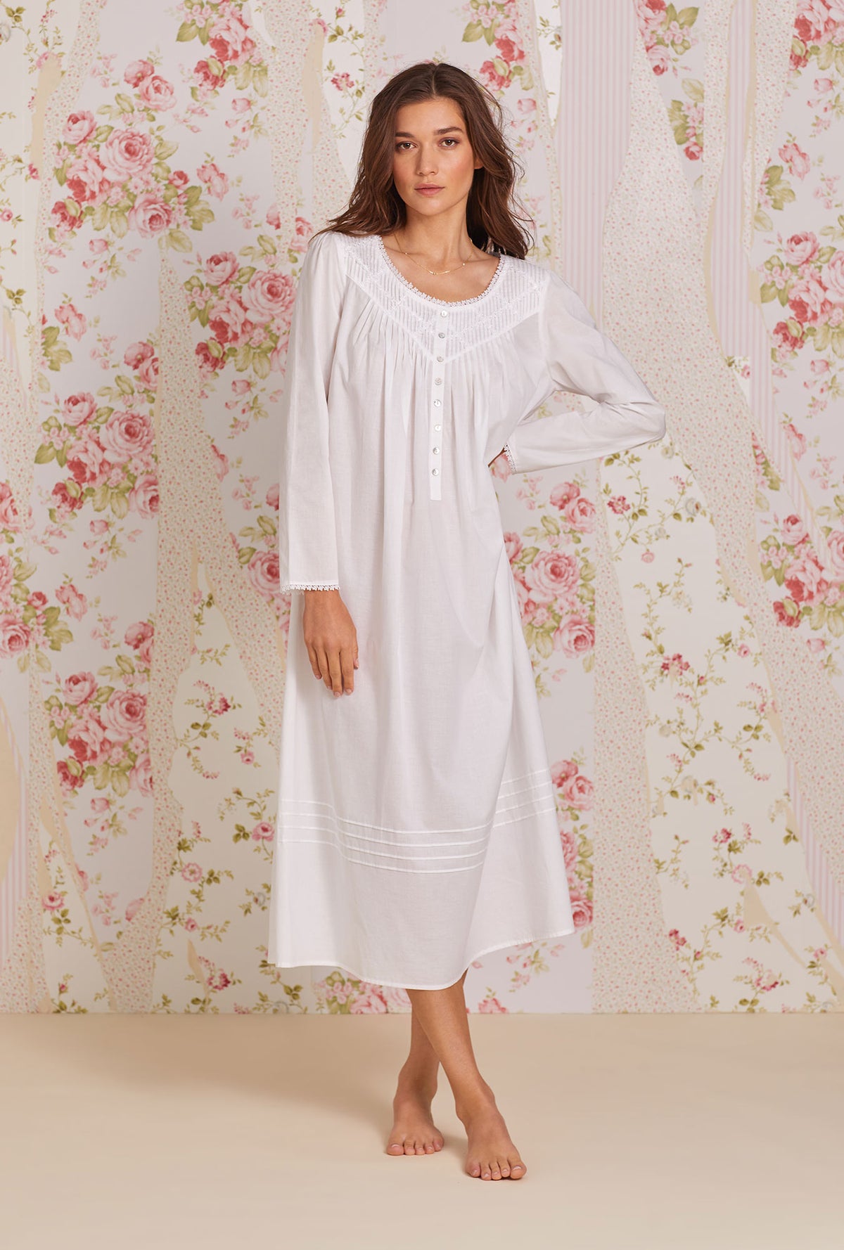 A lady wearing white long sleeve poetic nightgown.