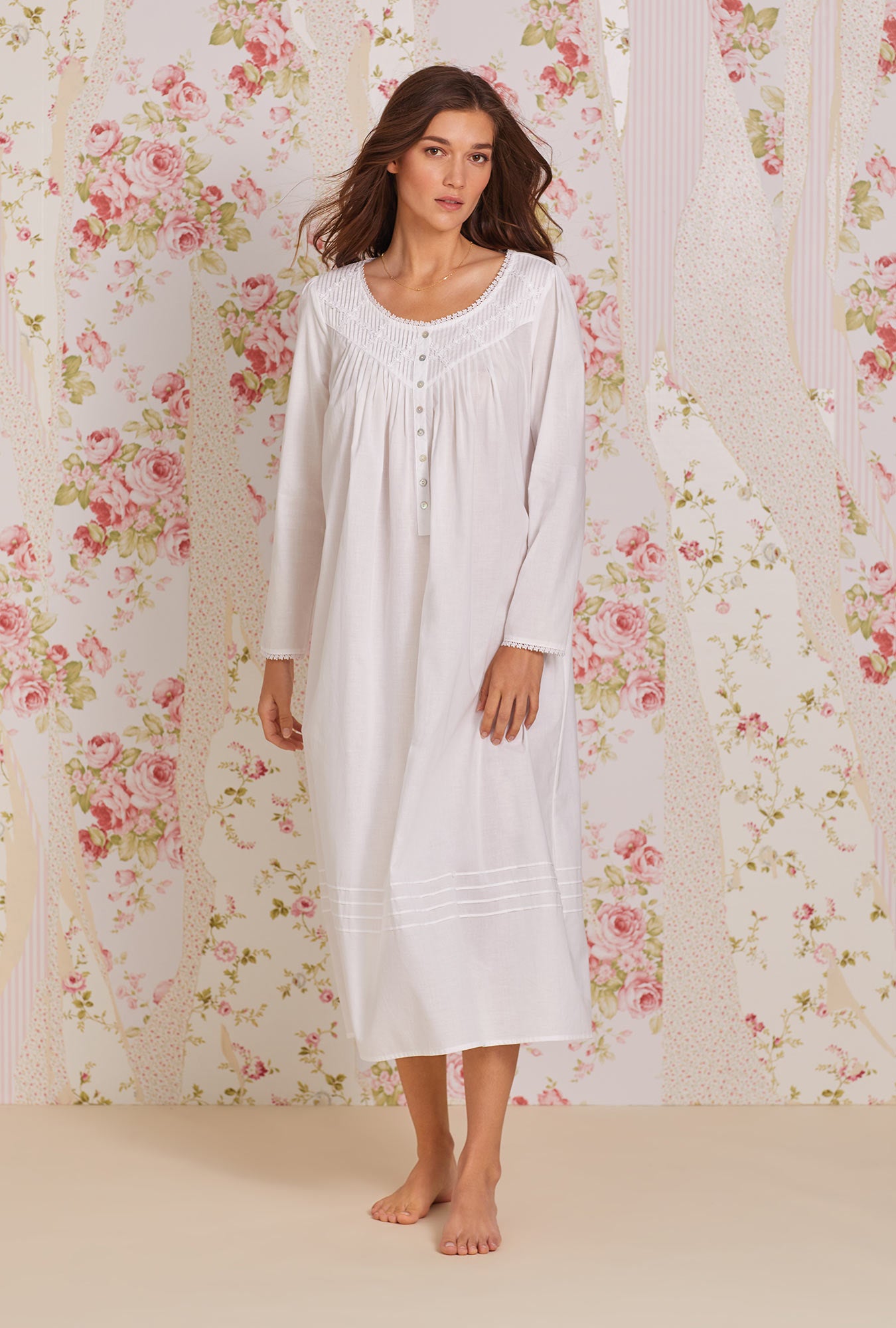A lady wearing white long sleeve poetic nightgown.