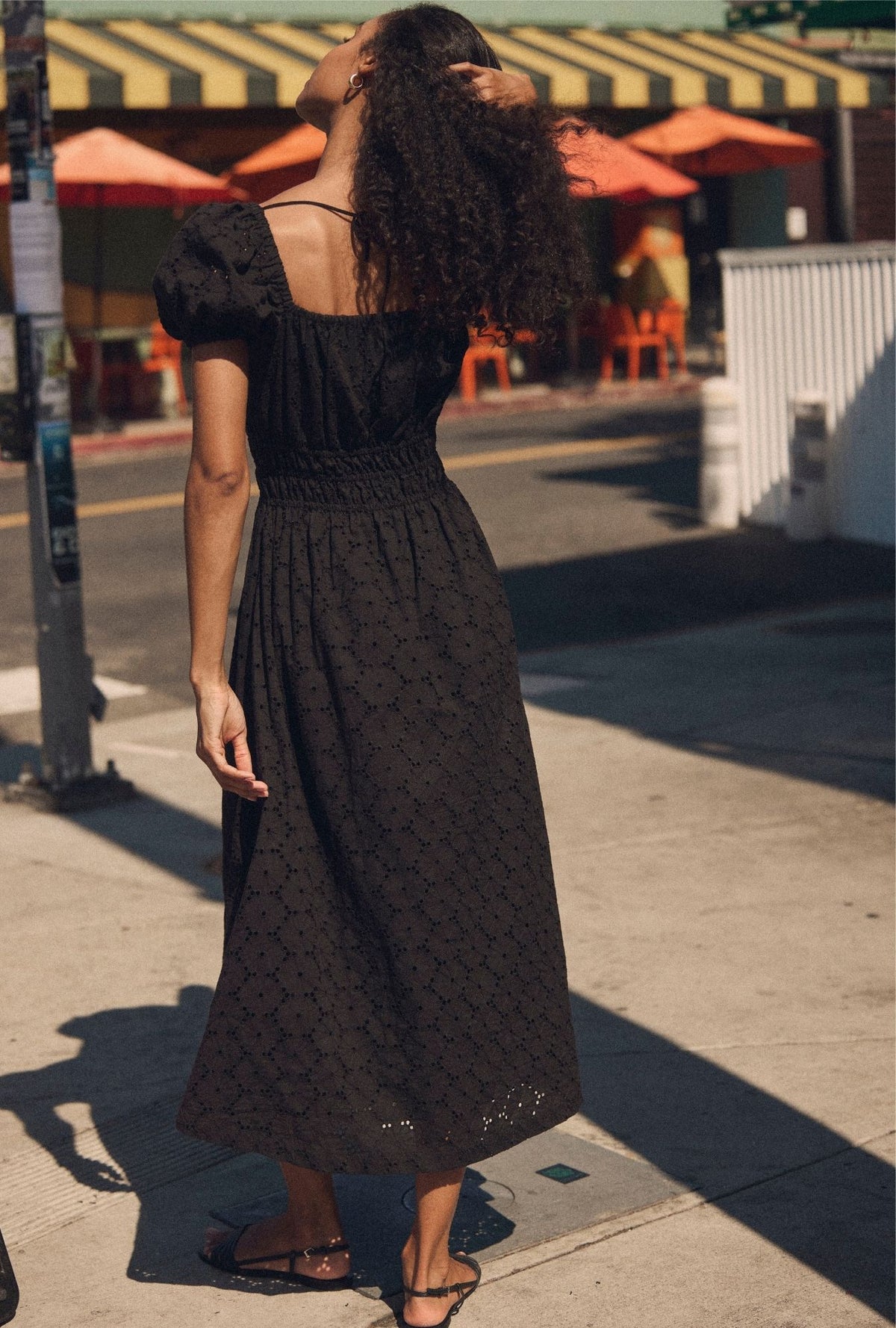 A lady wearing The "Catalina" Iconic Black Cotton Maxi Dress back view