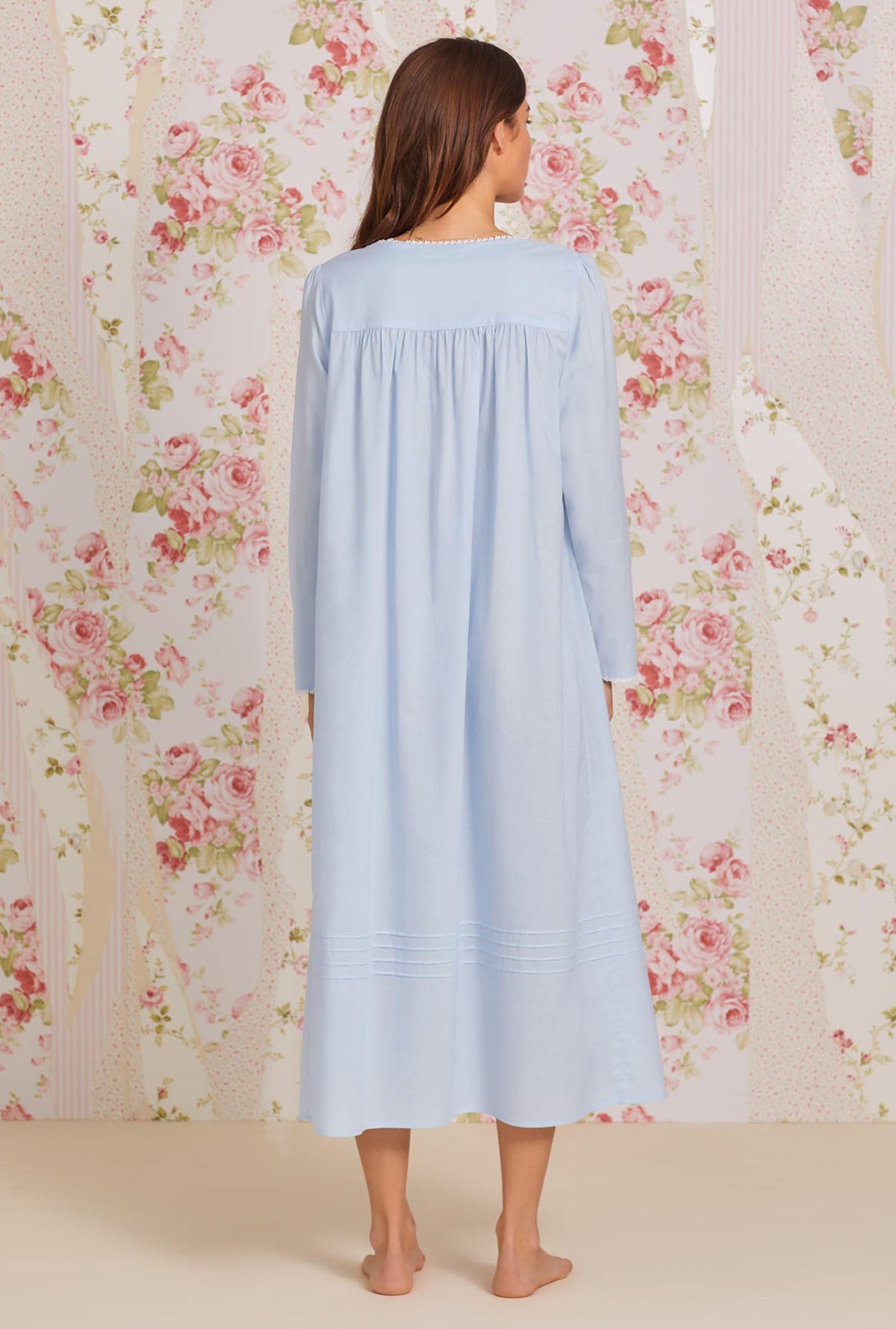 A lady wearing blue long sleeve poetic nightgown back view