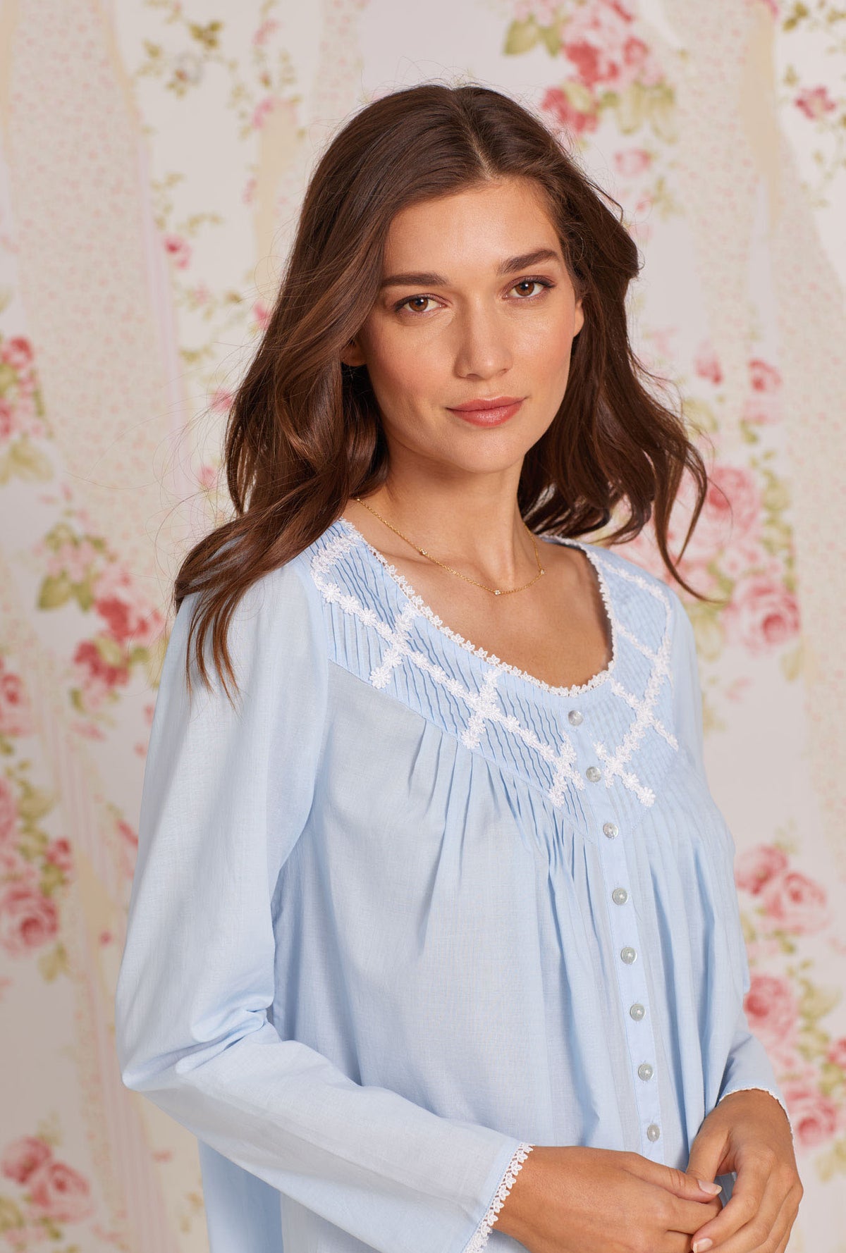 A lady wearing blue long sleeve poetic nightgown.