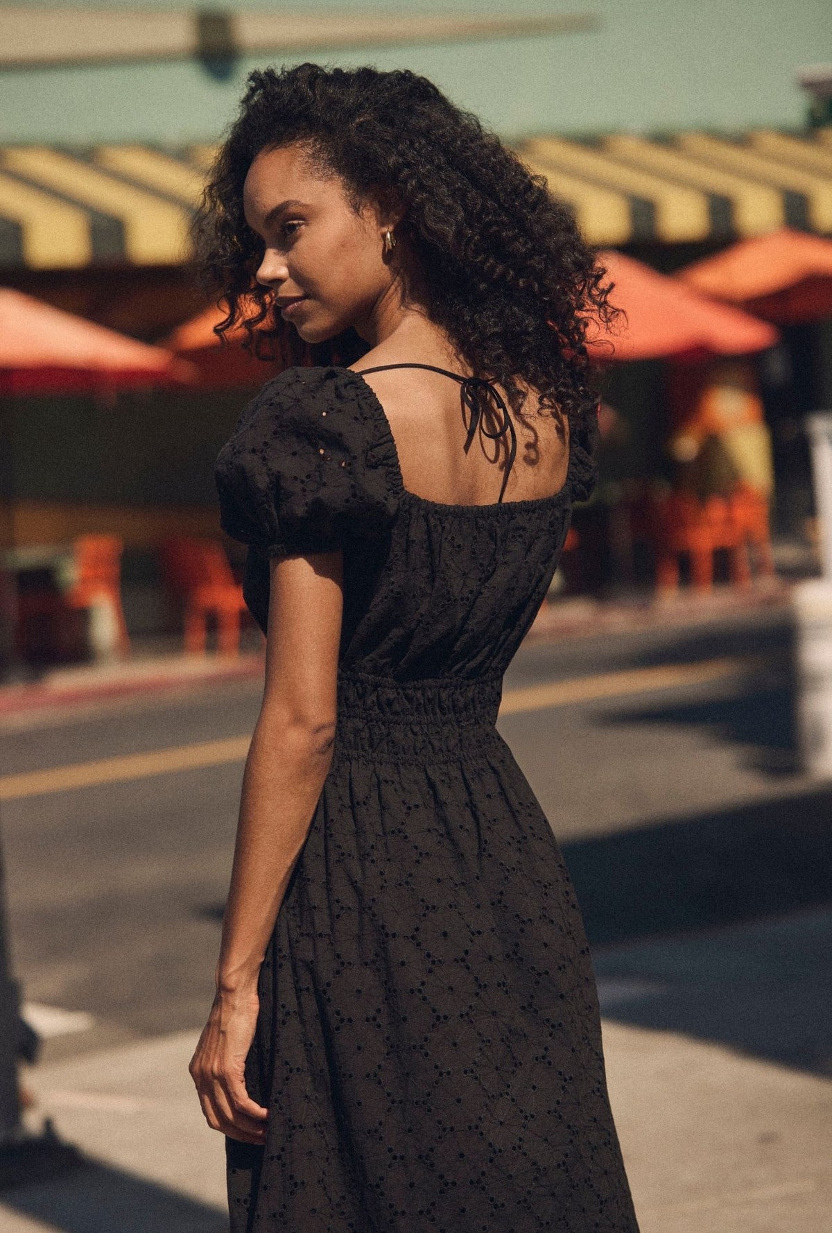 A lady wearing The "Catalina" Iconic Black Cotton Maxi Dress closer back view