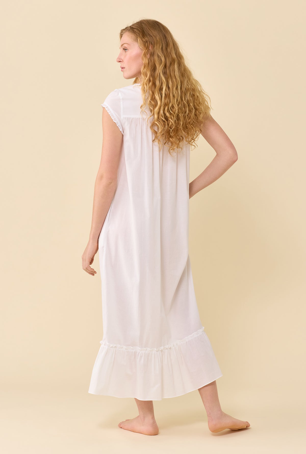 A Lady Wearing Soft White Robe in a back view pose 