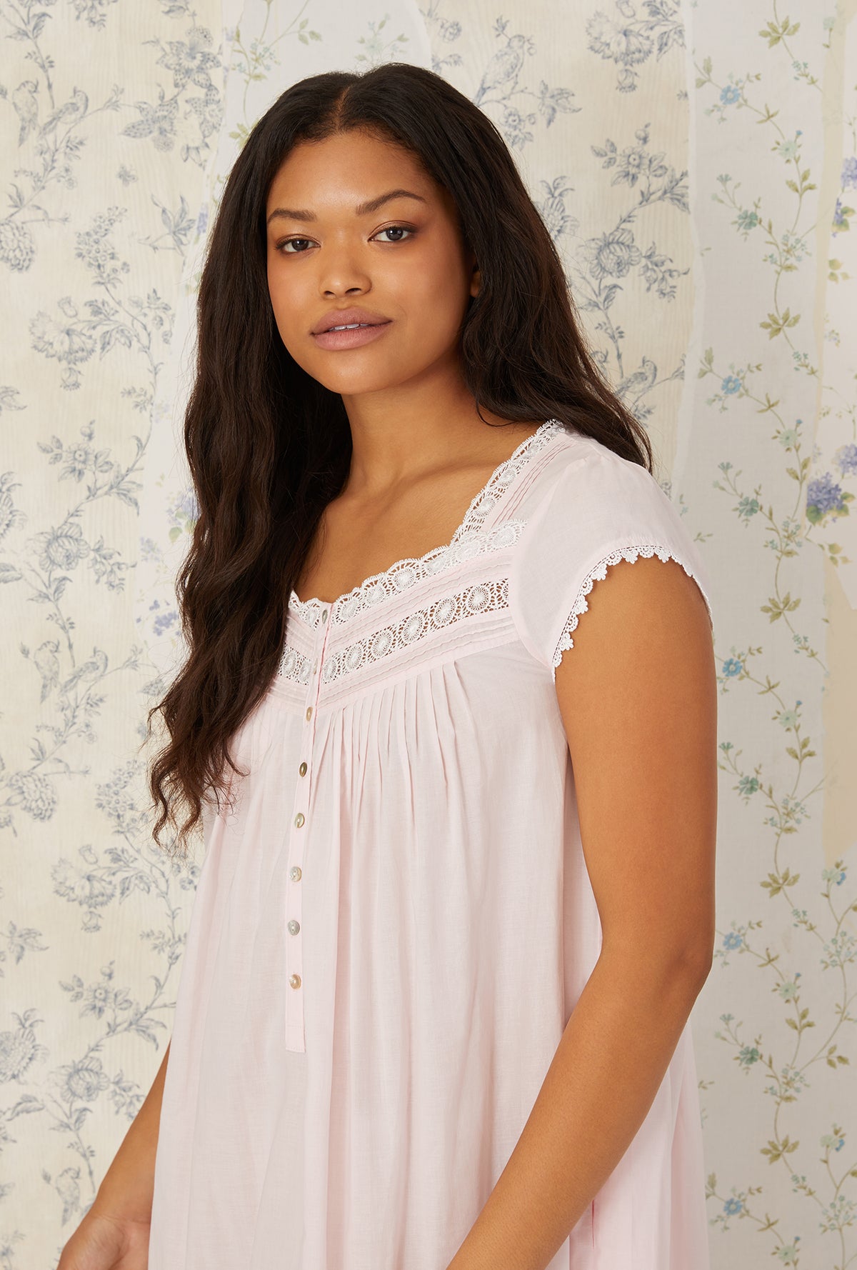 A lady wearing plus size Heirloom Dream Cap Sleeve Nightgown in blush pink in a close up view pose