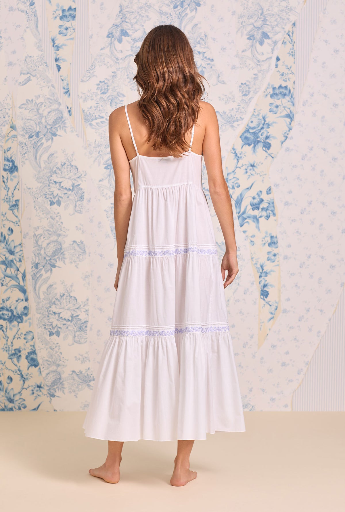 A lady wearing The "Ophelia" Iconic White Lavender Embroidered Ballet Nightgown back view