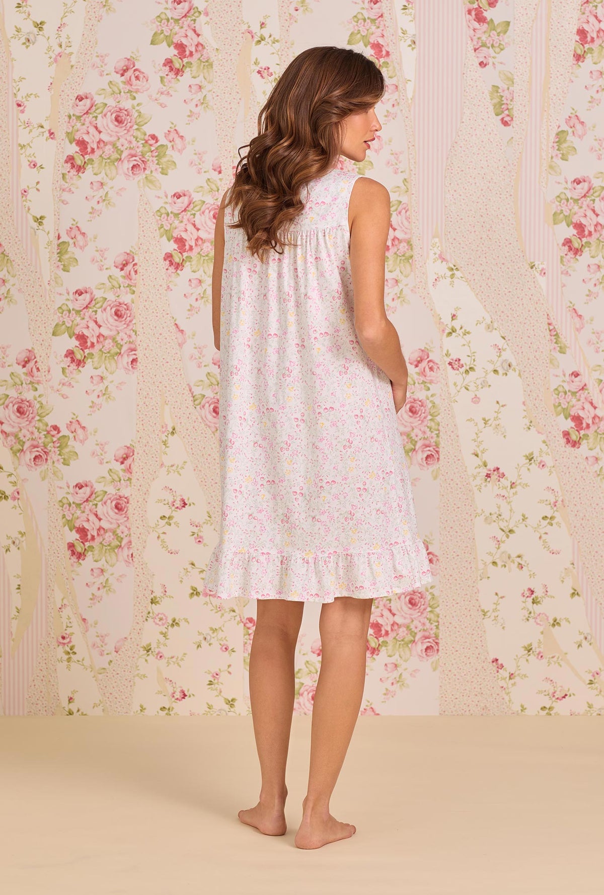 A Lady Wearing Strawberry Field Cotton Knit Chemise facing back view pose of the dress while looking to the side
