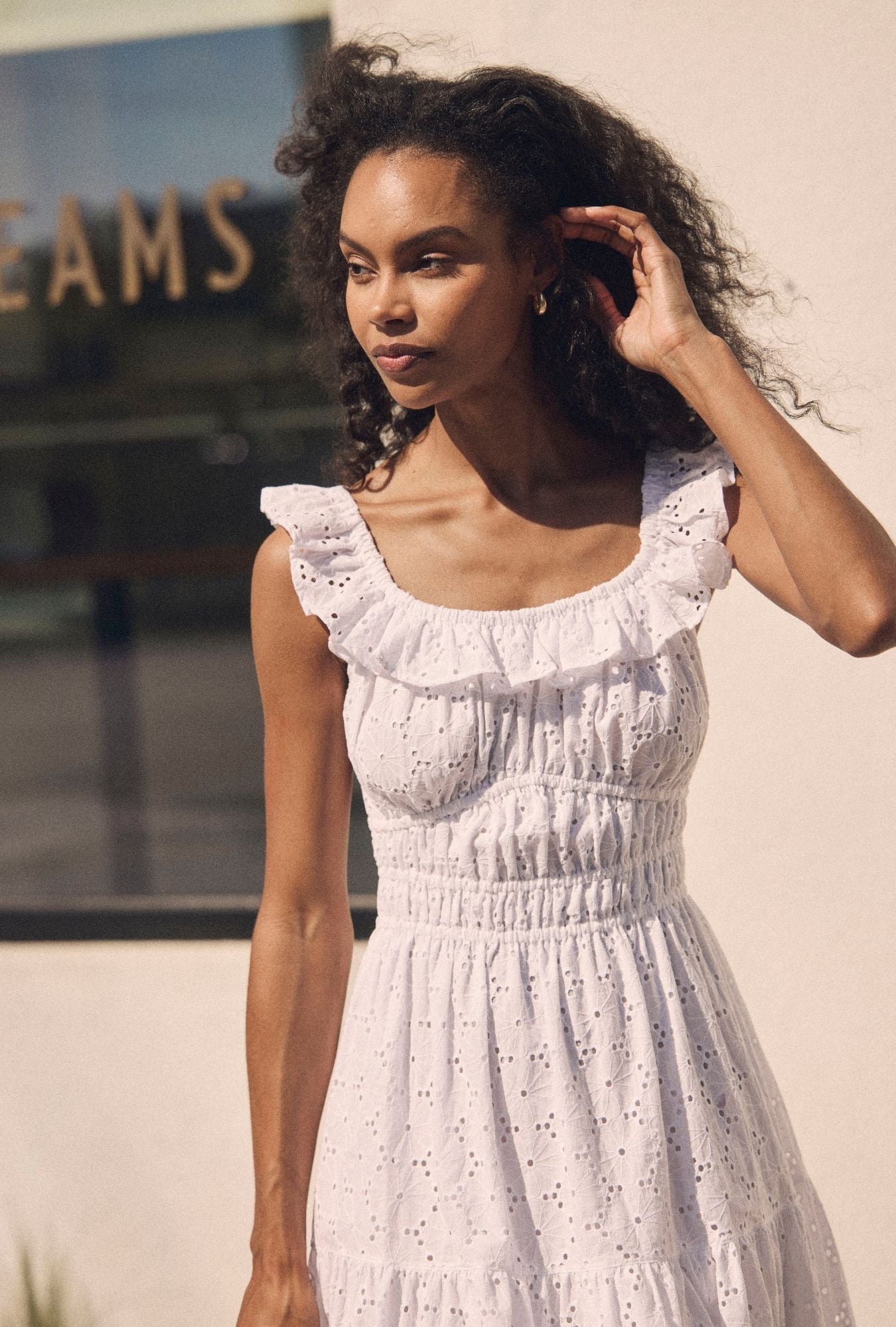 A lady wearing The "Isla" Soft White Cotton Maxi Dress closer look looking side