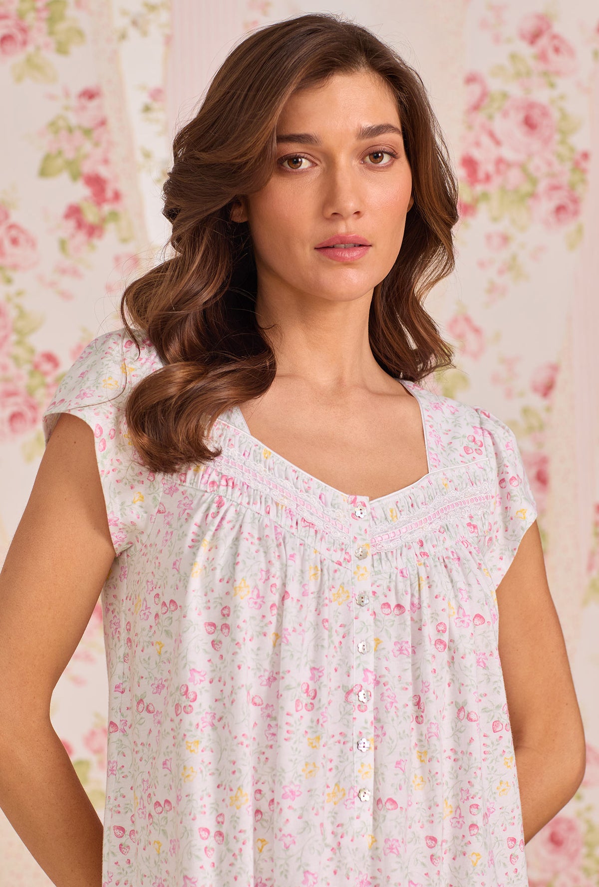 A Lady Wearing Strawberry Field Cotton Knit Cap Sleeve Ballet Nightgown facing front in half close up shot with her hands placed at the back of her waist