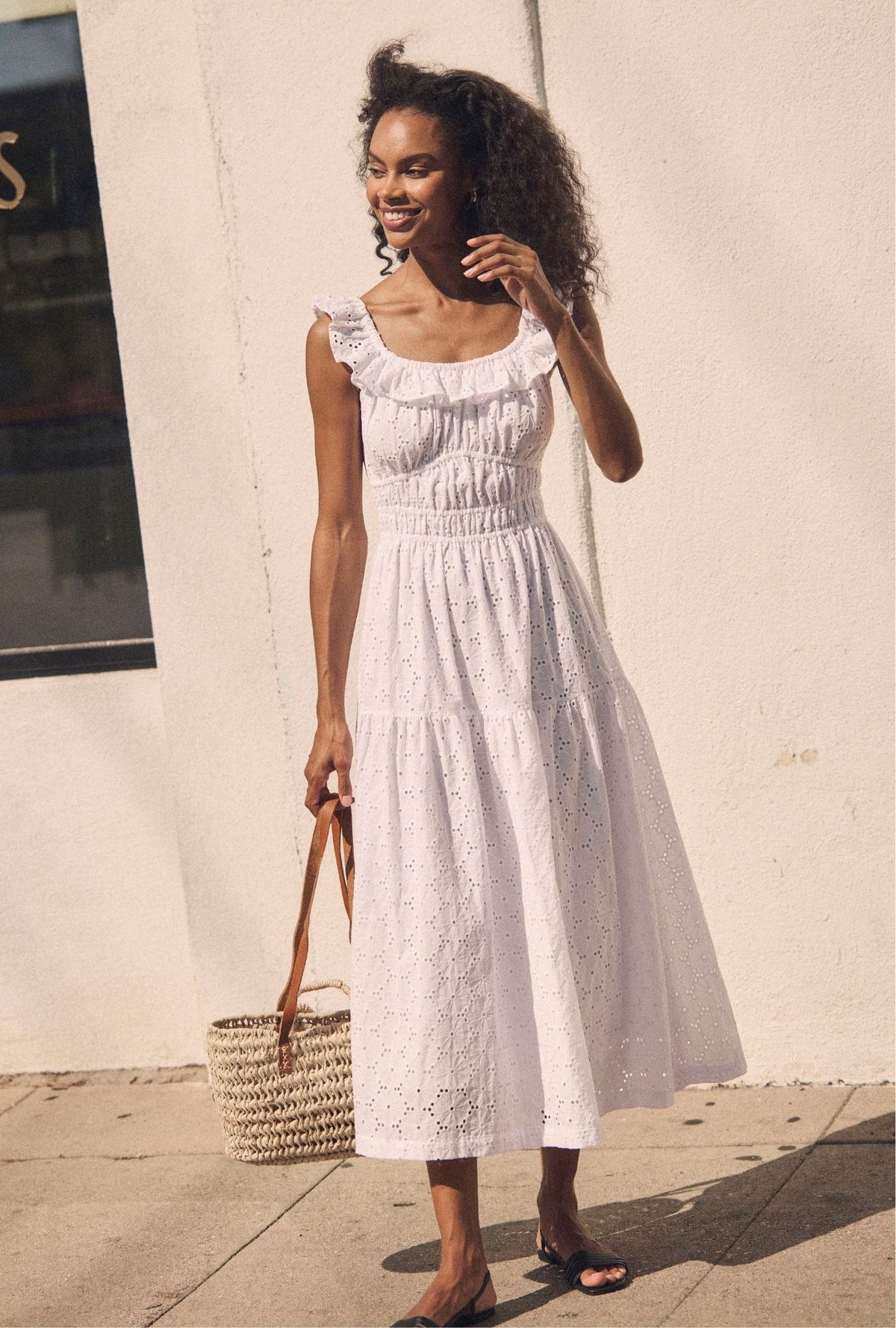 A lady wearing The "Isla" Soft White Cotton Maxi Dress looking side