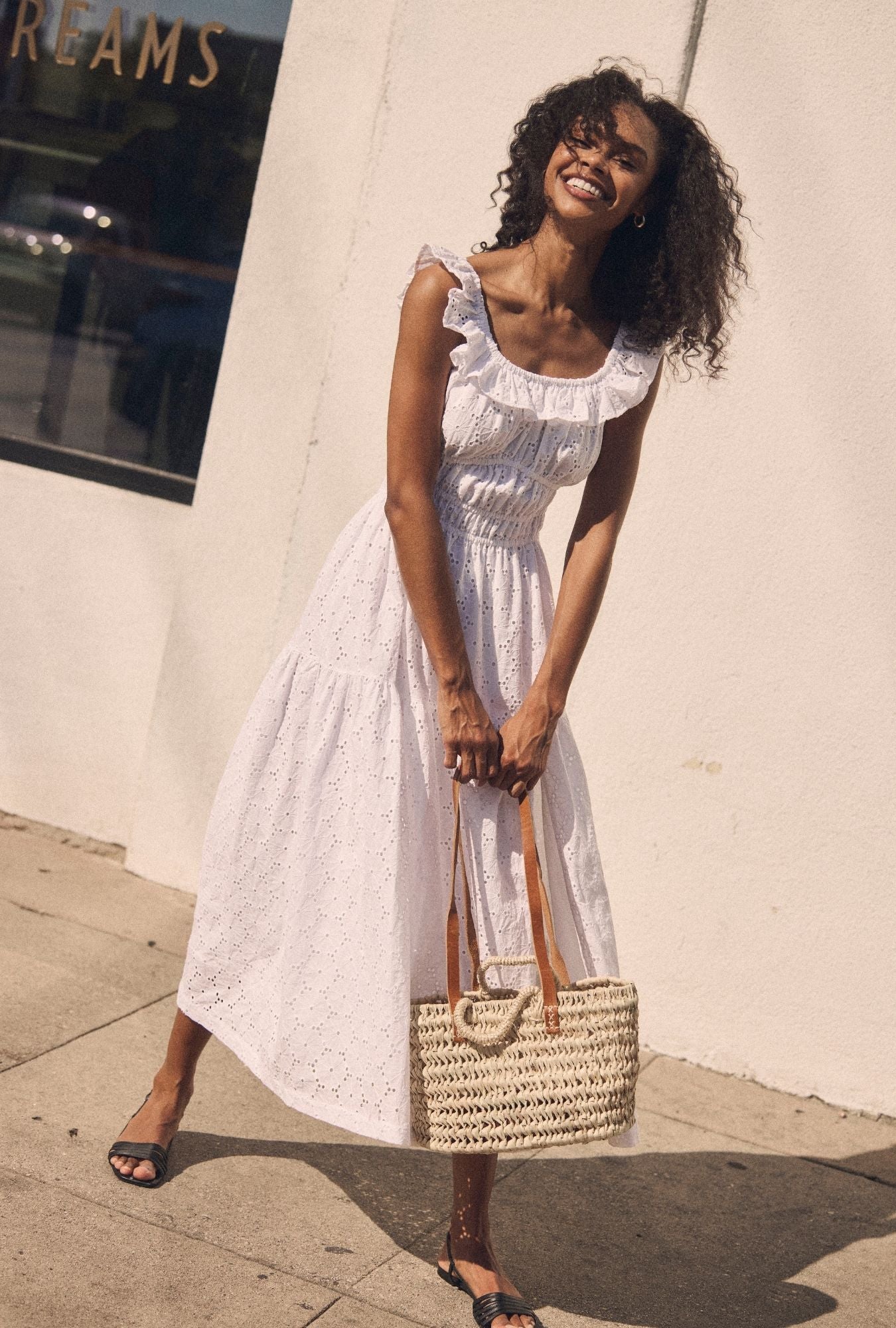 A lady wearing The "Isla" Soft White Cotton Maxi Dress