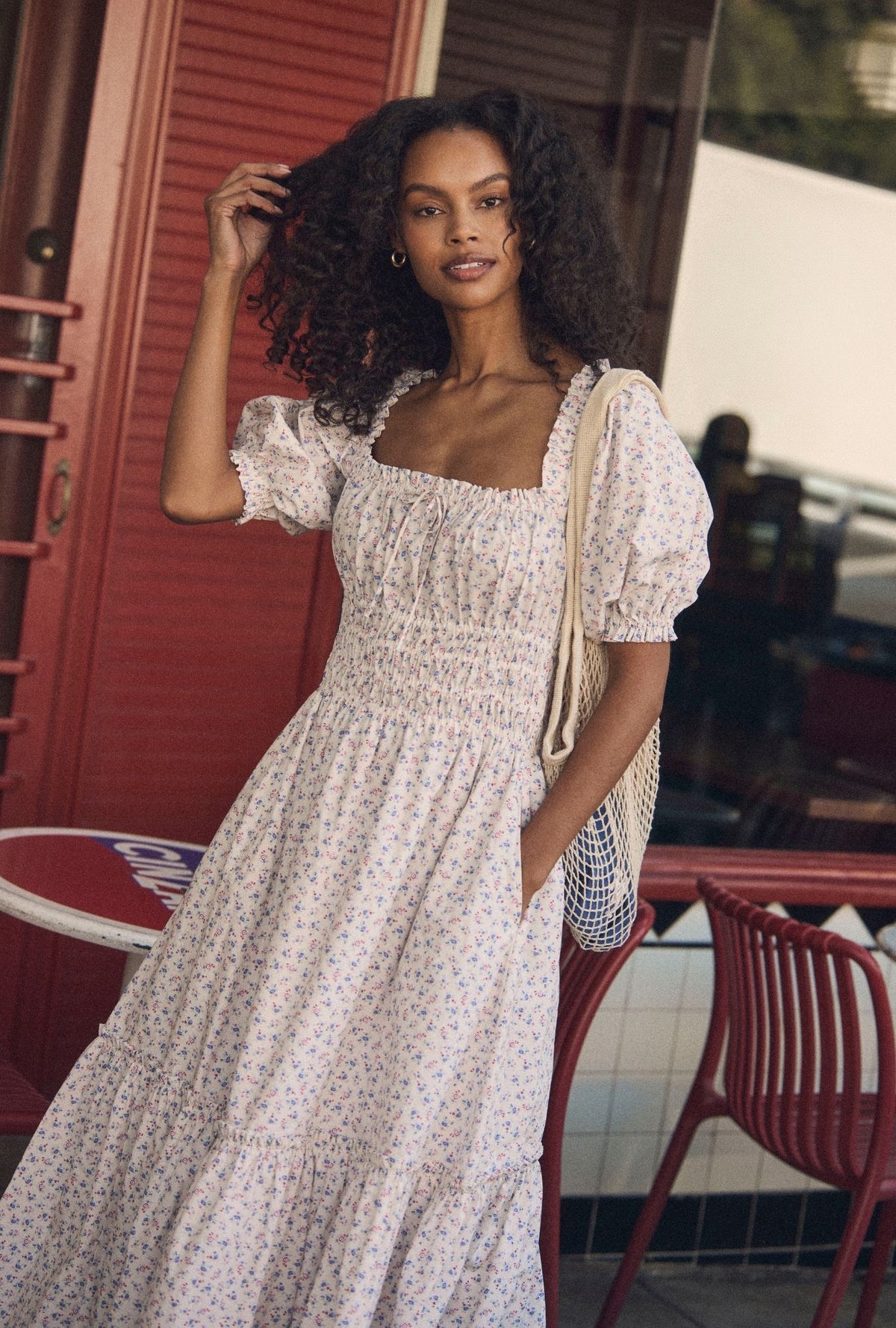 A lady wearing The "Marin" Buttercup Floral Cotton Maxi Dress