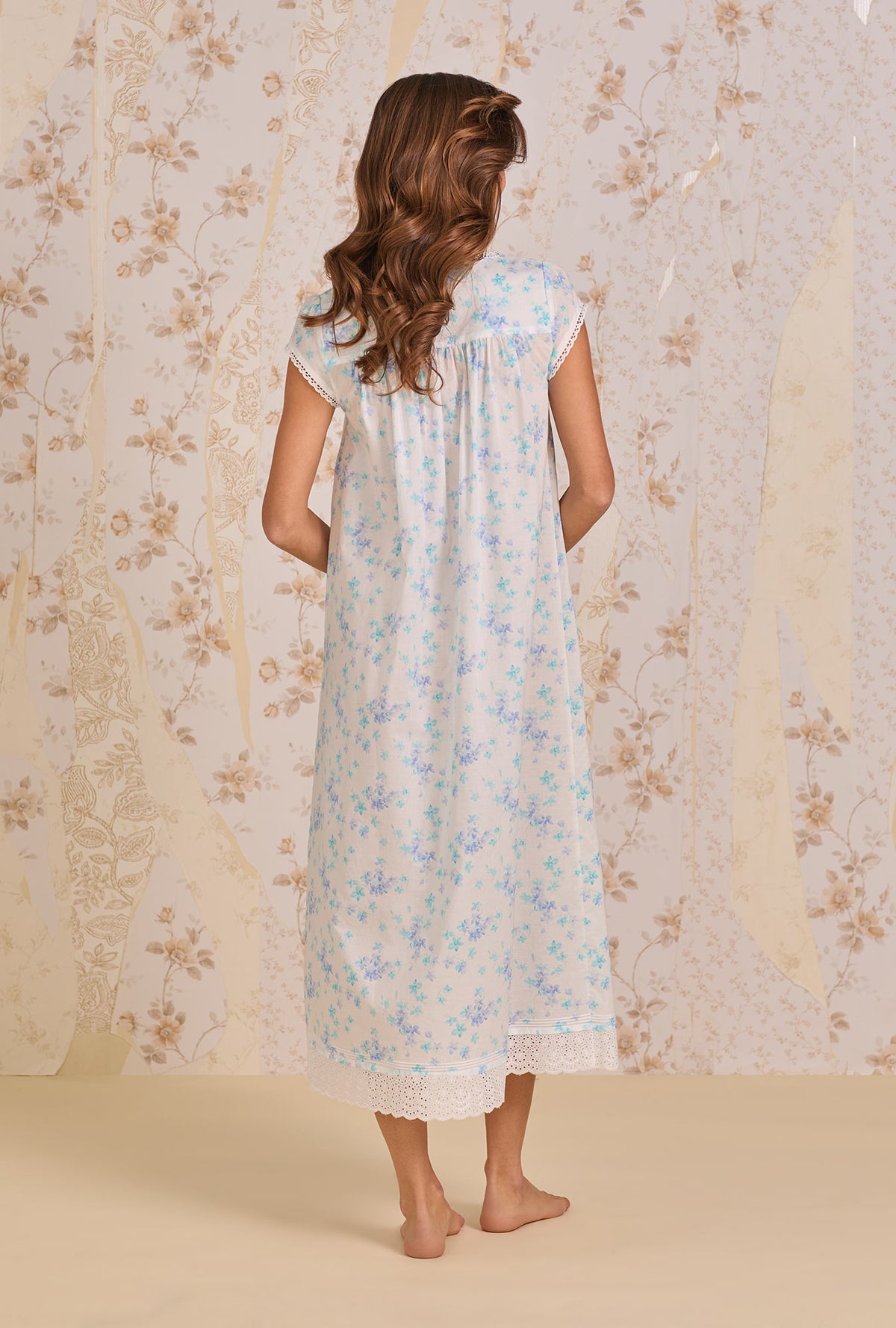 A lady wearing Riviera Floral Nightgown back view