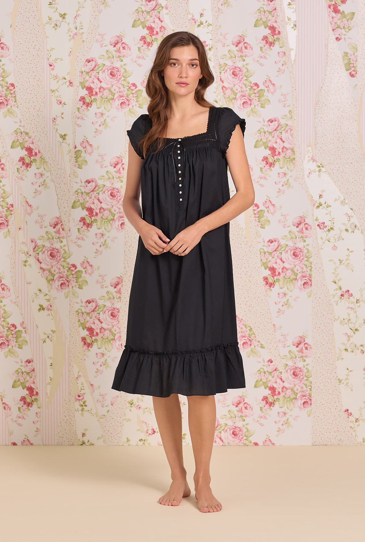 A Lady Wearing Iconic Black Cotton Lawn Cap Sleeve Waltz Nightgown Front view