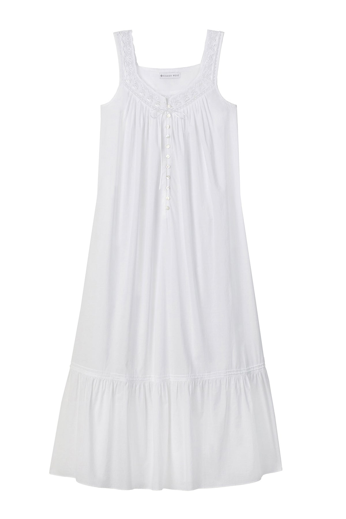A lady wearing white sleeveless elizabeth cotton nightgown with iconic pattern.