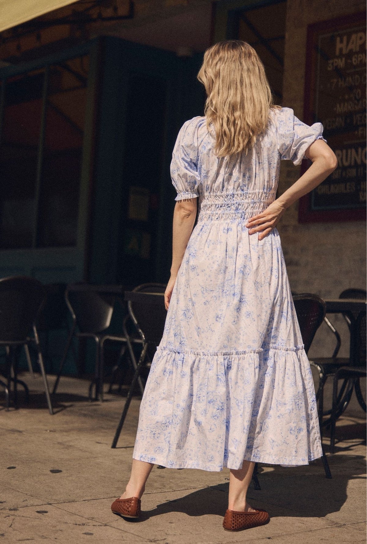 A lady wearing The "Marin" Coastal Toile Cotton Maxi Dress back view outside