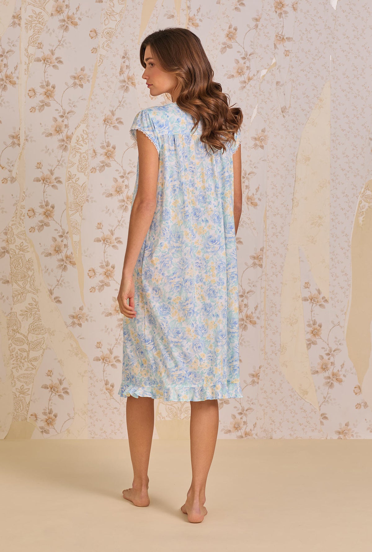 A lady wearing Cerulean Floral Waltz Nightgown back view