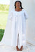 A lady wearing white robe