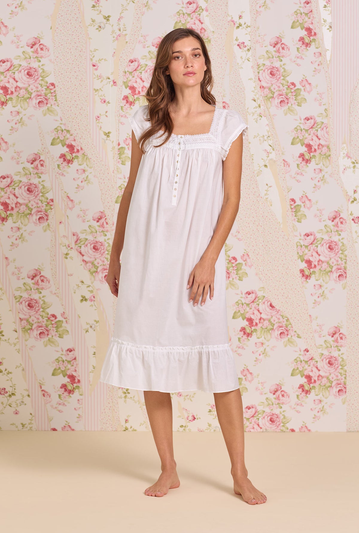 A Lady Wearing Iconic White Cotton Lawn Cap Sleeve Waltz Nightgown Front view