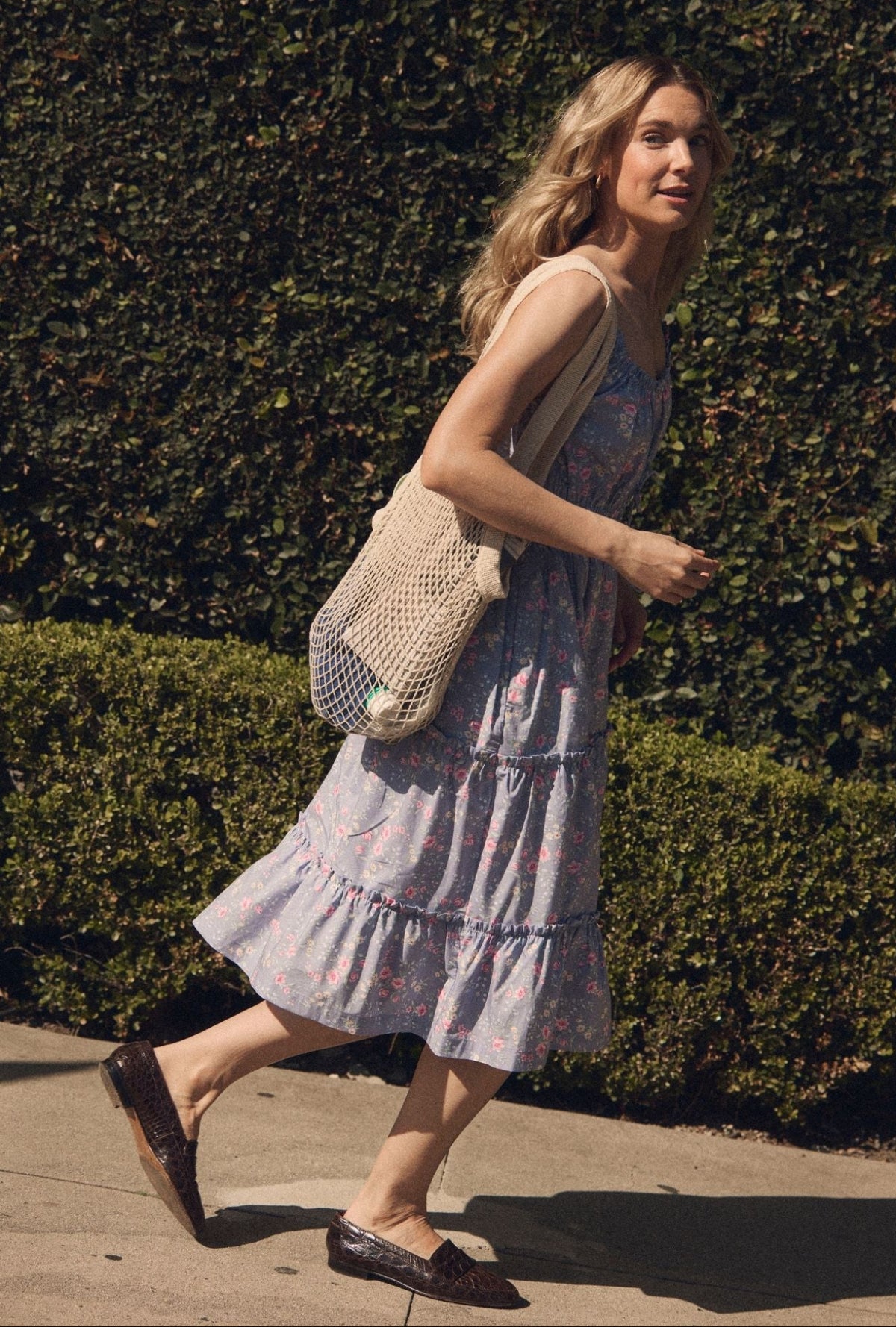 A lady wearing The "Nora" Chambray Rose Cotton Midi Dress side view walking