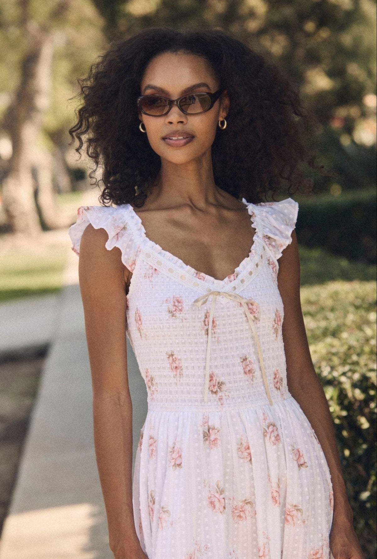 A lady wearing the "Ada" Venice Rose Cotton Swiss Dot Midi Dress closer view at  neck