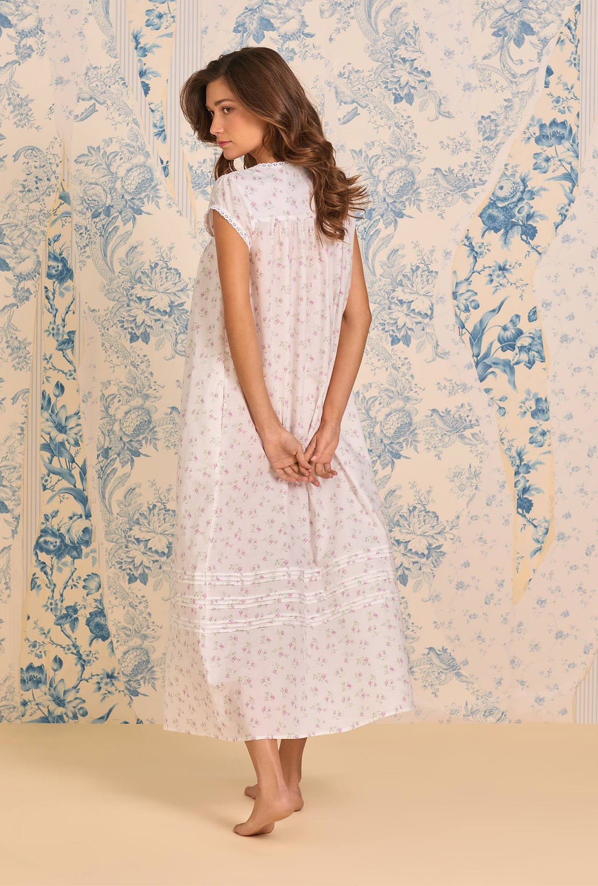 A Lady Wearing Petite Rose Cotton Lawn Button Front Robe posing a side angle back view