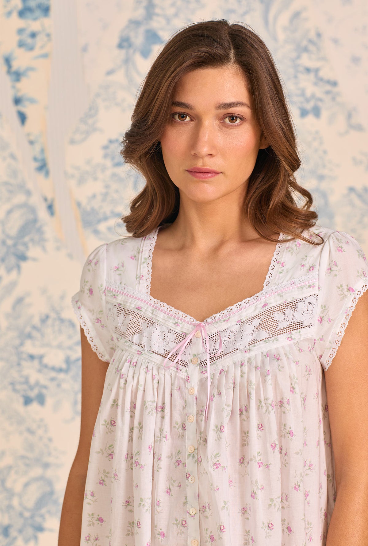 A Lady Wearing Petite Rose Cotton Lawn Button Front Robe facing front in a half close up shot looking straight