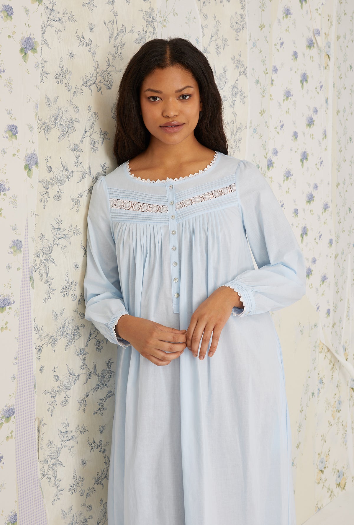 A lady wearing plus size light blue Heirloom Dream Long Sleeve Gown in a half close up shot