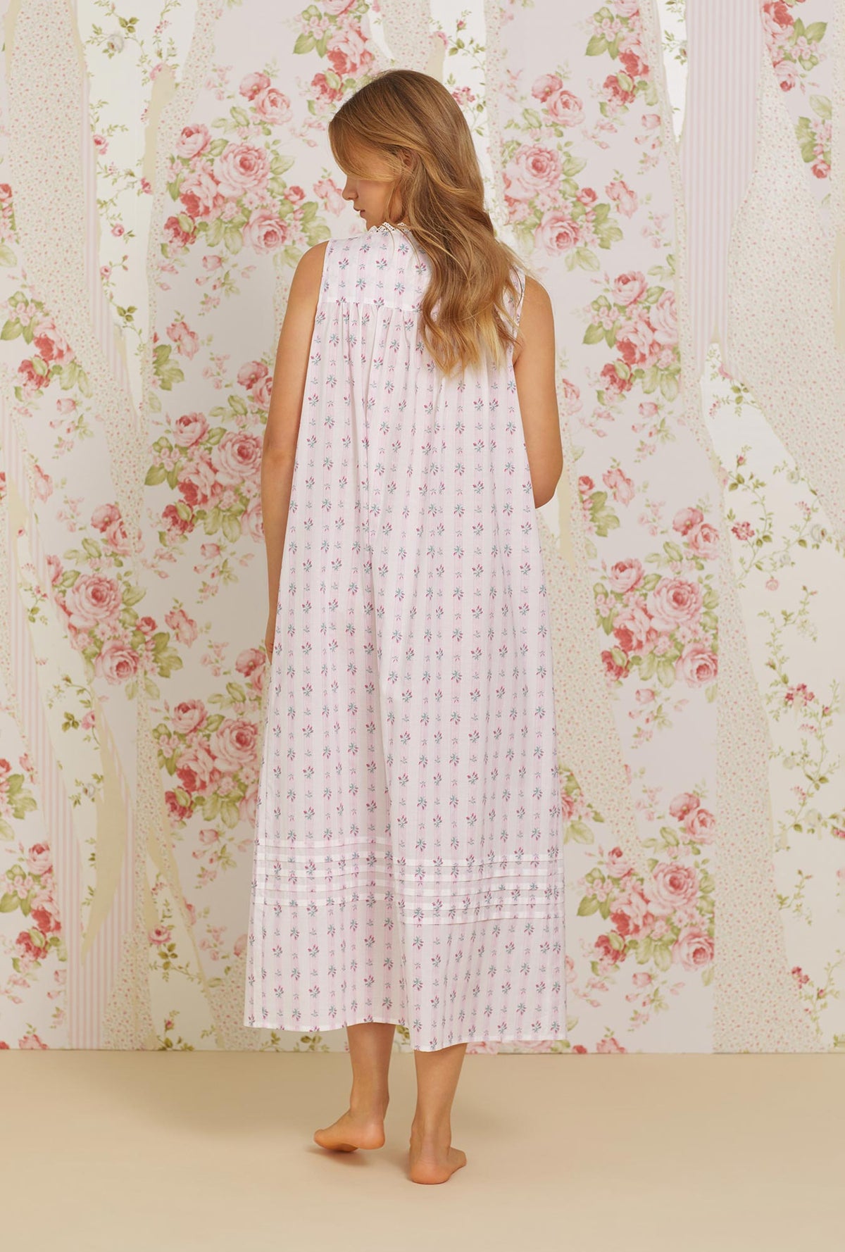 A lady wearing pink sleeveless eileen cotton woven nightgown with sweetest floral stripe print.