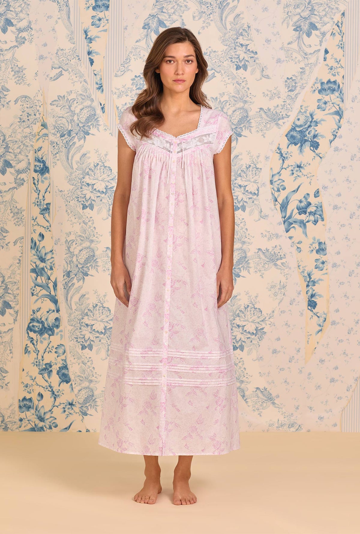 A Lady Wearing Blush Rose Cotton Lawn Button Front Robe facing front in a full standing pose looking to the straight