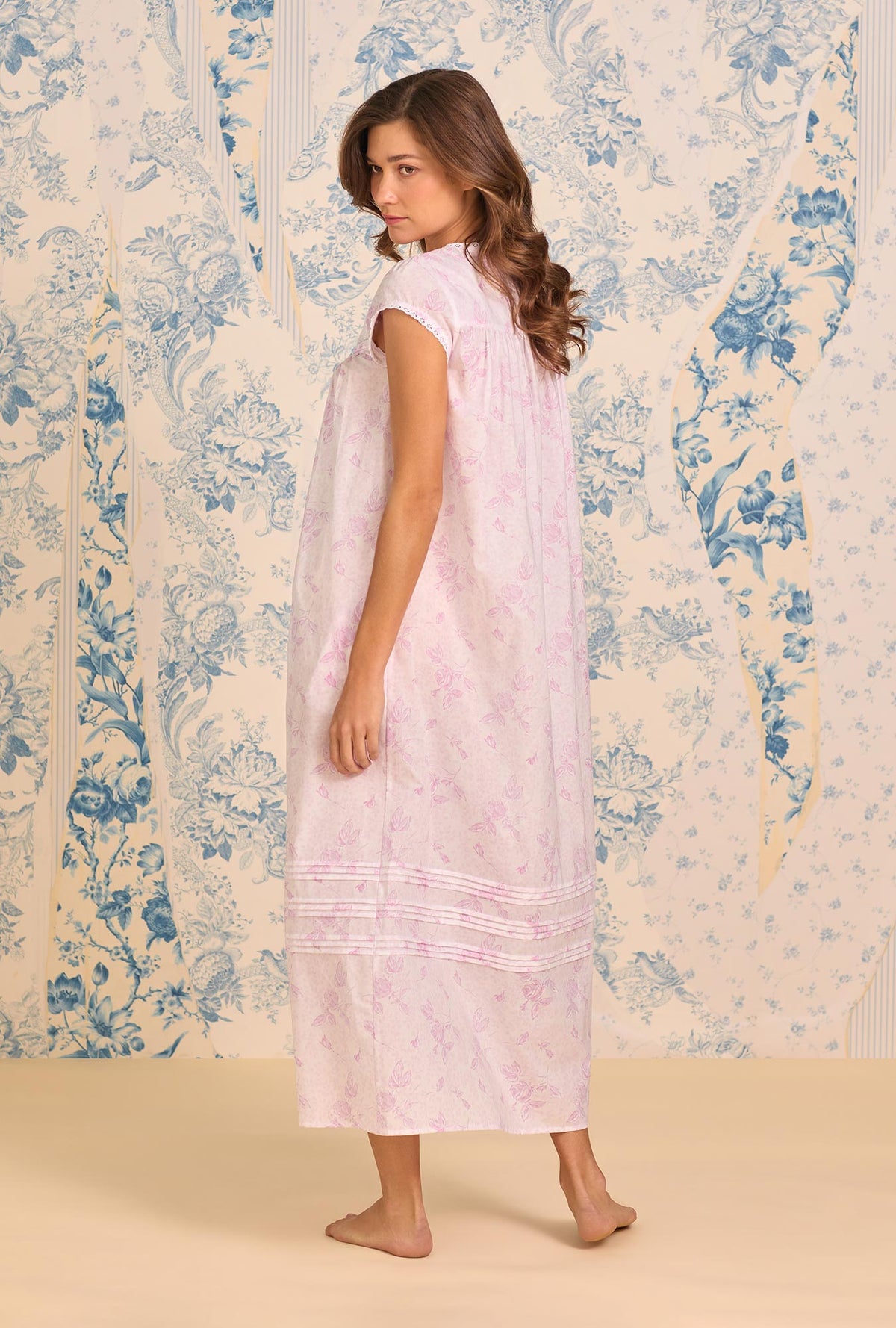 A Lady Wearing Blush Rose Cotton Lawn Button Front Robe posing back view in a slight angled pose