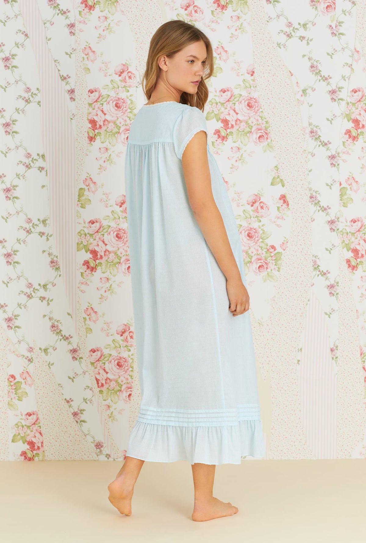 A lady wearing aqua cap sleeve  sheer stripe clip dot nightgown with summer cloud eileen pattern.