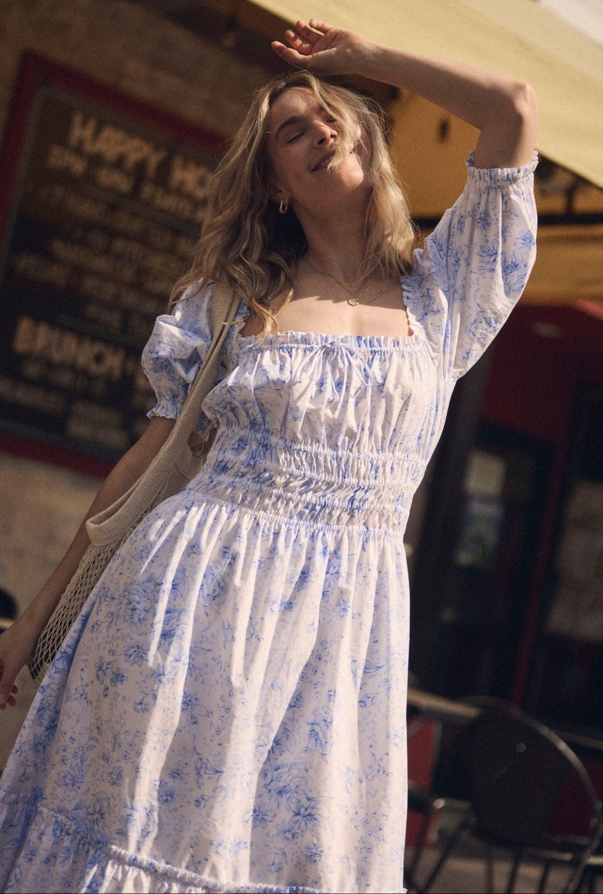 A lady wearing The "Marin" Coastal Toile Cotton Maxi Dress looking up outside