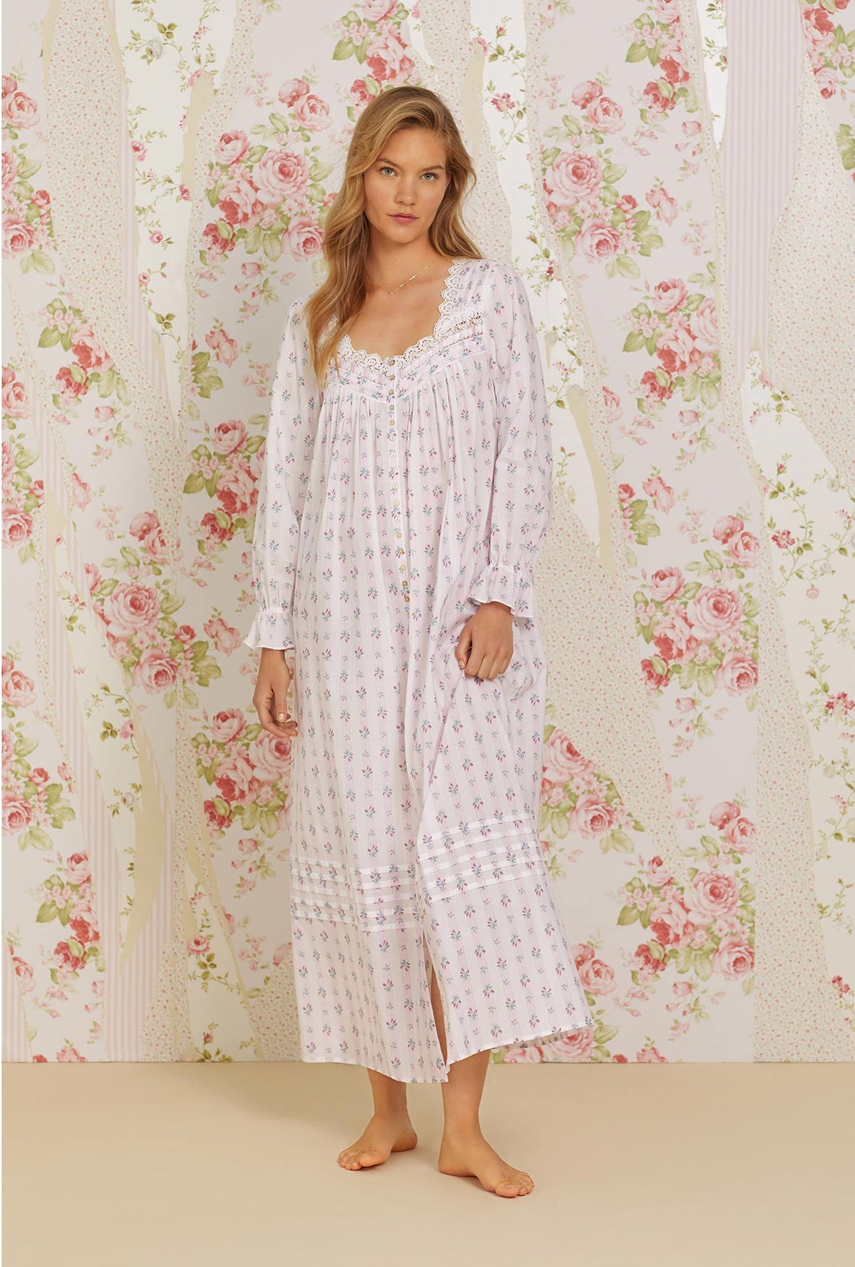 A lady wearing pink long sleeve long button front robe with sweetest floral stripe print.