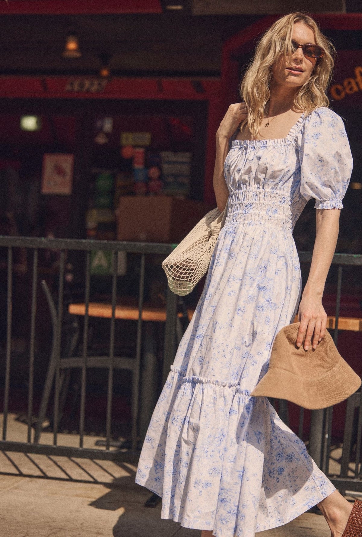 A lady wearing The "Marin" Coastal Toile Cotton Maxi Dress walking ouside